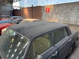many old cars parked in a lot next to each other