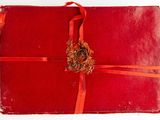 an image of a red book with a red ribbon and a gold medallion on it