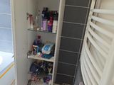 a bathroom with a towel rack and a towel rack in the corner