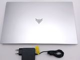 a laptop with a charger attached to it on a table
