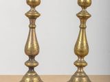 pair of antique brass candlesticks on a wooden table