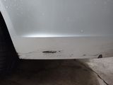 a close up of a white car with a lot of scratches on it