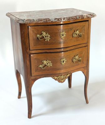 a small marble top chest of drawers on a stand