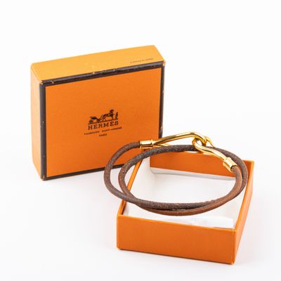 une boîte orange contenant un bracelet en cuir marron