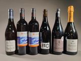 bottles of wine are lined up in a row on a table