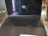 a laptop computer sitting on a glass table in a store