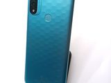 a close up of the back of a blue phone on a white surface