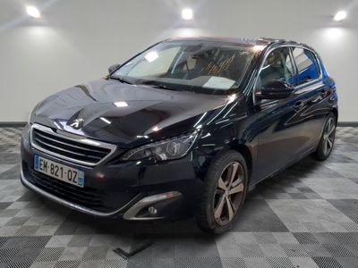 La voiture noire est garée sur le sol à damier du garage.
