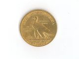 a gold coin with a bird on it on a white surface