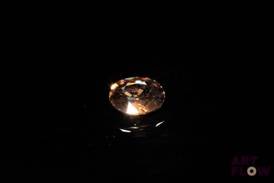a close up of a diamond on a black surface