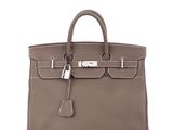 a brown leather handbag on a white background