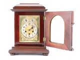 a small wooden clock with a mirror in it