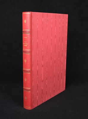 a red book sitting on top of a black surface