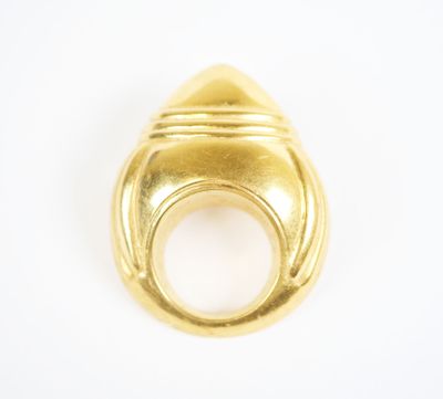 a close up of a gold ring on a white surface