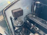 a small engine in the back of an old car