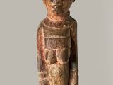 a wooden statue of a man with a hat on his head