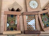 four wooden frames and a clock sitting on a shelf