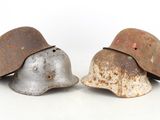 two helmets sitting next to each other on a white surface