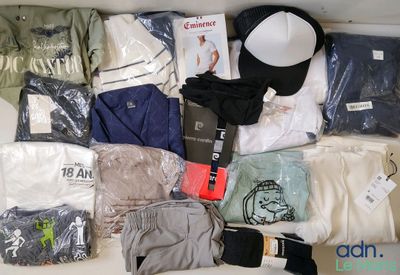 a lot of clothing and a hat on a table