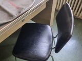 a computer desk with a chair and a computer on it