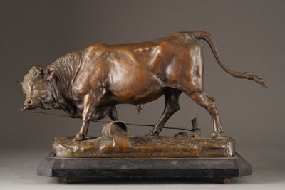 bronze statue of a bull on a wooden base with a rope