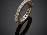 a white gold ring with diamonds on a black surface