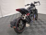 a picture of a black motorcycle parked on a checkered floor