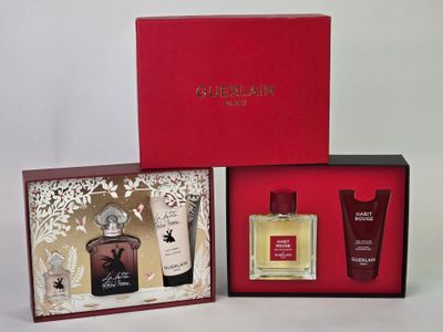 three different types of perfumes in a red box on a white surface