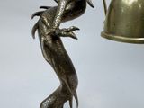 a statue of a bird with a bell on it ' s head