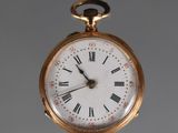 a gold pocket watch with roman numerals on the face