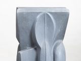 sculpture on a white pedestal with a white background