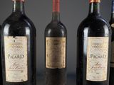 four bottles of wine are lined up on a table