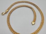a gold chain with a clasp on a white background