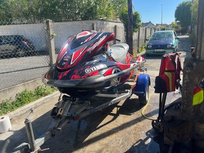 a red and black jet ski being pulled by a trailer
