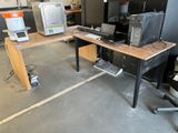 a computer desk with a monitor and a keyboard on it