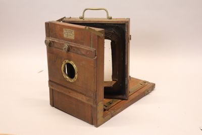 a small wooden box with a camera inside of it