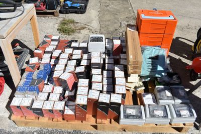 many boxes of cigarettes on a pallet on the ground