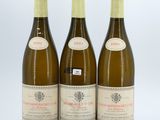 three bottles of wine sitting next to each other on a white surface