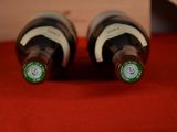 two bottles of wine that are sitting on a table