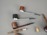 many different types of smoking pipes on the table