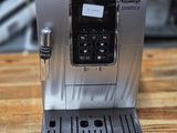 an espressor machine sitting on a wooden table in a kitchen