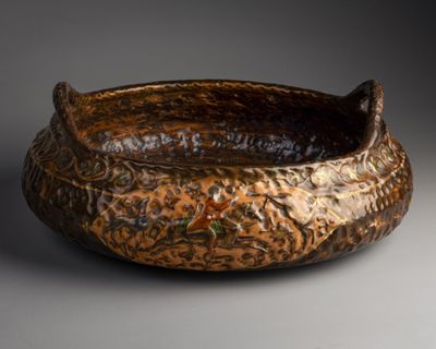 a brown bowl that is sitting on a table