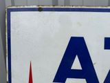 a white sign with blue letters and a red arrow on it