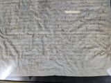 a piece of paper with writing on it in a glass case