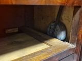 a wooden shelf with a clock on it in a room