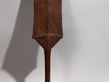 an old wooden spatula on a white background with a shadow