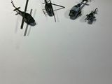 a lot of small black and white helicopters on a white surface