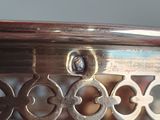 a close up of a metal table with a clock on it