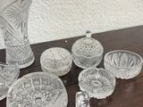 a lot of glass items sitting on a wooden table