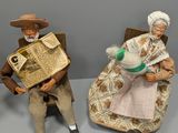 many figurines of people sitting on a table